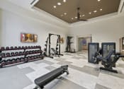 Thumbnail 19 of 25 - a spacious fitness room with weights and cardio equipment