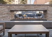 Thumbnail 33 of 34 - Outdoor lounge area next to a fireplace
