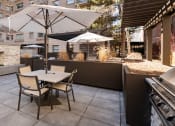 Thumbnail 34 of 34 - Outdoor seating area next to BBQ grill and a fireplace