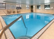 Thumbnail 25 of 34 - Indoor swimming pool with windows and seating areas