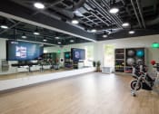 Thumbnail 23 of 34 - Fitness studio with large mirror along wall with two TVs