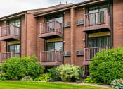 Thumbnail 6 of 10 - Back exterior view of Garden Apartments showing units with balconies