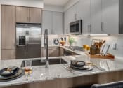 Thumbnail 2 of 35 - kitchen with granite counter tops and stainless steel appliances