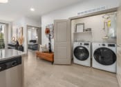 Thumbnail 5 of 35 - a washer and dryer in a laundry room with a sink and a door