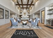 Thumbnail 15 of 35 - a living room with blue chairs and a rug that reads the grove on man