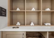 Thumbnail 28 of 35 - a bathroom with a white counter and shelves with
