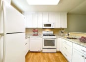 Thumbnail 25 of 27 - Kitchen With White Cabinetry And Appliances at Carrington Apartments, Fremont, California