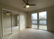 Thumbnail 11 of 12 - Cozy bedroom with plush carpet, mirrored closet doors, and large vindows at 3543 Brook Street in Lafayette, CA 94549