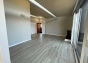 Thumbnail 9 of 12 - living room with wood-look flooring and a large window at 3543 Brook Street in Lafayette 94549
