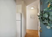 Thumbnail 46 of 46 - A hallway with a white door and a blue wall.