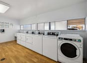 Thumbnail 43 of 46 - A laundry room with a washer and dryer.