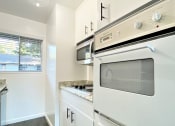 Thumbnail 30 of 30 - Kitchen with Oven and Hardwood Floors at 2120 Valerga in Belmont, California 94002