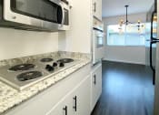 Thumbnail 28 of 30 - Kitchen with Stove Top and Microwave  at 2120 Valerga in Belmont, 94002