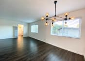 Thumbnail 25 of 30 - Stunning Living Room with Hardwood Floors, Modern Lighting, and Large Windows at 2120 Valerga in Belmont, CA 94002