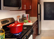 Thumbnail 8 of 38 - a kitchen with a pot on the stove and a blackboard on the wall