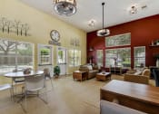 Thumbnail 5 of 39 - a living room with a table and chairs in front of a window