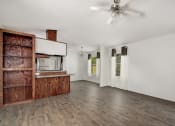 Thumbnail 31 of 39 - a living room with white walls and a wooden cabinet