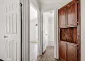 Thumbnail 27 of 39 - a hallway with a wooden cabinet and a white door