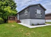 Thumbnail 2 of 39 - a gray house with white siding and a brown house in the background