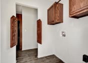 Thumbnail 22 of 39 - a room with white walls and wooden cabinets