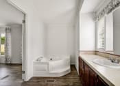 Thumbnail 12 of 39 - a bathroom with a bathtub and a sink