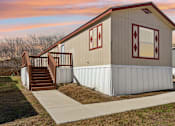 Thumbnail 32 of 39 - A small house with a red diamond pattern on the wall.