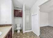 Thumbnail 22 of 22 - A bathroom with a toilet, sink, and shower.
