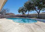 Thumbnail 17 of 39 - A small pool with a concrete floor and a concrete wall.