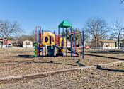 Thumbnail 19 of 39 - A playground with a yellow slide and a green roof.