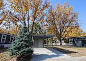 Thumbnail 7 of 46 - a house with a covered porch and a tree in front of it at Circle Park, Cheyenne