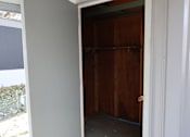 Thumbnail 39 of 46 - an open door into a room with a wood closet at Circle Park, Cheyenne, Wyoming