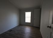 Thumbnail 43 of 46 - an empty room with a door and a window at Circle Park, Cheyenne, WY