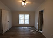Thumbnail 42 of 46 - an empty living room with a ceiling fan and a window at Circle Park, Wyoming