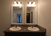 Thumbnail 33 of 46 - a bathroom with two sinks and two mirrors at Circle Park, Cheyenne, Wyoming