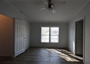 Thumbnail 37 of 46 - an empty room with a ceiling fan and a window at Circle Park, Cheyenne, WY