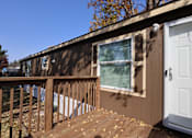 Thumbnail 28 of 46 - the tiny house has a deck with a door and a window at Circle Park, Wyoming, 82007