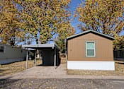 Thumbnail 9 of 46 - the front of a small house with a garage and trees at Circle Park, Cheyenne, 82007