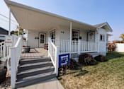 Thumbnail 12 of 22 - the front of a white house with a porch and a no parking sign at Country Lane, Cheyenne, WY