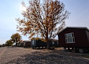 Thumbnail 7 of 22 - a row of tiny houses on the side of a road at Country Lane, Cheyenne