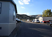 Thumbnail 5 of 20 - a parking lot in a trailer park with mountains in the background at Horizon MHC, Rock Springs, WY 82901