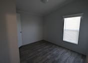 Thumbnail 12 of 20 - an empty room with wood floors at Horizon MHC, Rock Springs