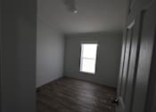 Thumbnail 19 of 20 - an empty room with a window and wooden floors at Horizon MHC, Wyoming