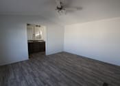 Thumbnail 15 of 20 - an empty living room with wood flooring and a ceiling fan at Horizon MHC, Rock Springs, WY