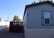 Thumbnail 7 of 20 - the exterior of a tiny house with a deck and a window at Horizon MHC, Rock Springs, Wyoming
