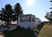 Thumbnail 6 of 9 - the exterior of a mobile home on the side of a street at Kimberly Village, Cheyenne