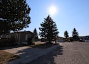 Thumbnail 9 of 9 - the sun shining over a street in a neighborhood with houses at Kimberly Village, Cheyenne, WY