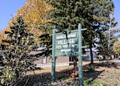 Thumbnail 2 of 7 - the sign for mobile home village in front of a house at Mobile Home Village, Cheyenne, WY