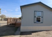 Thumbnail 12 of 19 - the tiny house has a porch and a deck with a window at Pioneer Park, Green River