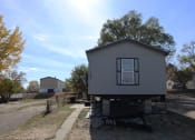 Thumbnail 10 of 19 - a tiny house on a trailer in the middle of the street at Pioneer Park, Green River, 82935