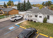 Thumbnail 1 of 22 - a white house with a car parked in a parking lot at Country Lane, Wyoming, 82007